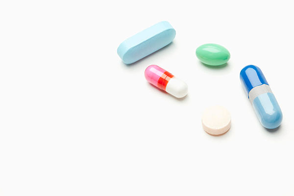 1 pills and capsules on white background vstock llc